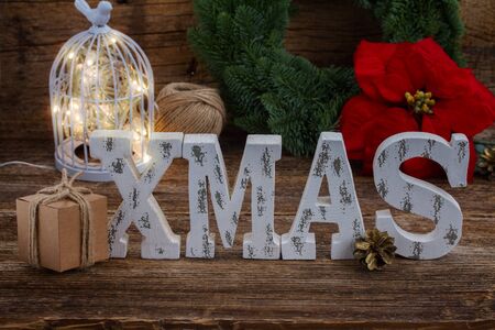 Xmas letters and handmade  with fir tree wreath in backgroundの写真素材