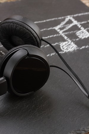 Music notes drawn on black and headphonesの写真素材