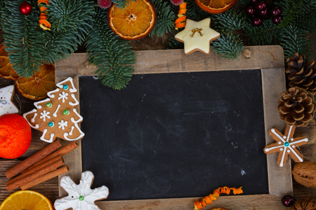 christmas gingerbread cookies with fir tree frame with blackboardの写真素材