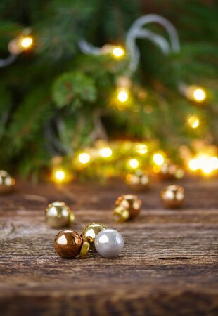wooden desk  with defocused christmas  lights and glass ballsの写真素材