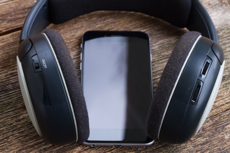 Black hedphones with modern smartphone close upの写真素材