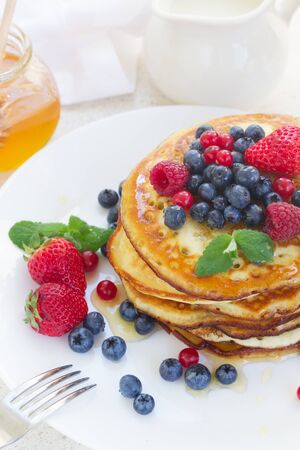 Plate of pancakes with  fresh berries on table close upの写真素材
