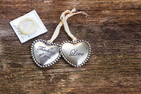 Safe love concept - two hearts with condom