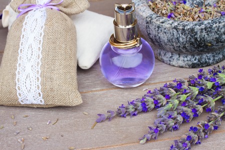 Lavender herbal water in a glass bottle with fresh and dry flowersの写真素材