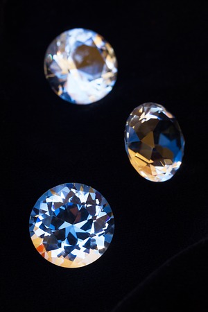 Three diamonds on black velvet silk background
