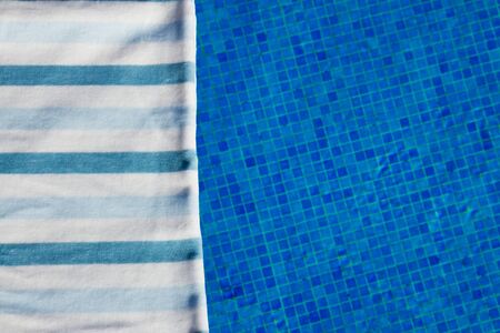 resort background with striped towel  near pool  sideの写真素材