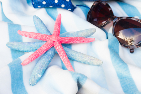 striped  beach towel, starfish   and sun glassesの写真素材