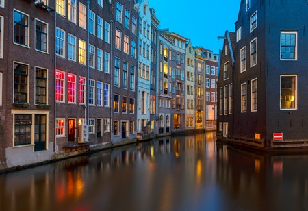 Houses over canal with reflections at night, Amstardam, Netherlandsの写真素材