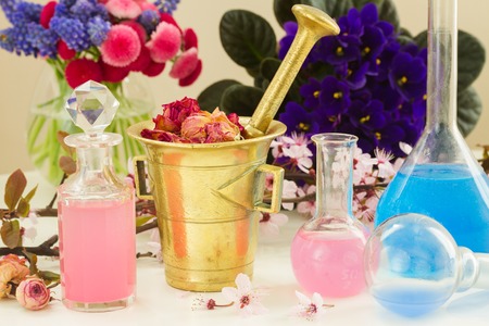 Dry flowers and vials  of tincture or oil, aromatherapy and herbal medicine concept