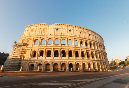 famous ruins of Colosseum at sunrise in Rome, Italyの写真素材