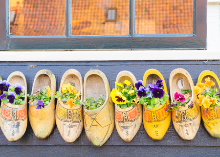 Traditional dutch shoes clogs with fresh flowersの写真素材