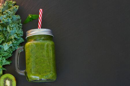 Fresh green smoothy drink on black with igredients with copy spaceの写真素材
