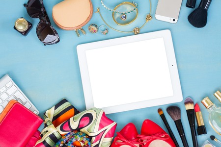 woman fashion items on blue wooden background, copy space on tablet screenの写真素材