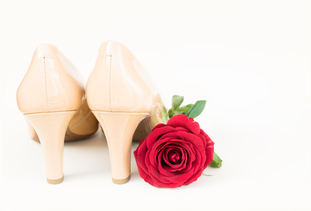 Nude colored high heels still life with red roseの写真素材