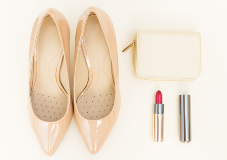 Nude colored high heels still life with wallet and red lipstickの写真素材