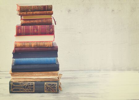 tower of books on white wooden desktop, retro tonedの写真素材