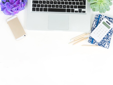 Modern Laptop keyboard and phone on white table mock up flat lay scene, copy space on tableの写真素材