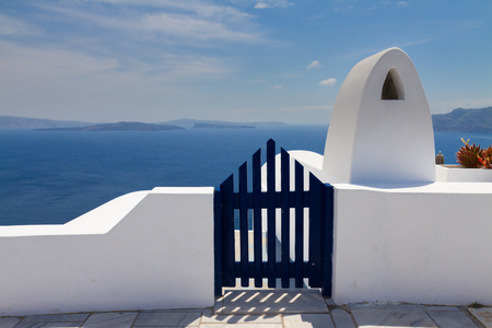 dark blue gates against volcano caldera and Aegan sea, beautiful details of Santorini island, Greeceの写真素材