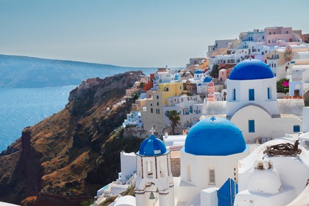 Oia, traditional greek village of Santorini with blue domes of churches, Greeceの写真素材