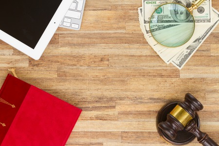 Wooden Law Gavel with legal book, dollars and pc keyboard