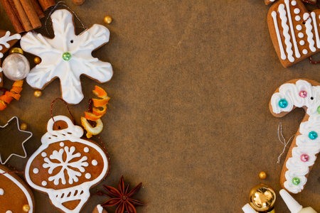 christmas gingerbread cookies with christmas decorations on cooking paper with copy spaceの写真素材