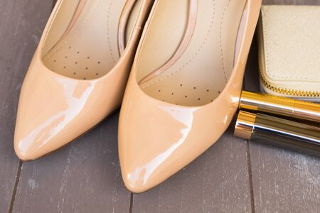Nude colored high heels still life with wallet and lipstick close upの写真素材