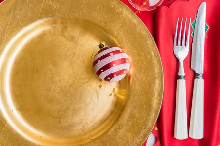 Christmas empty golden plate served for dinner close upの写真素材