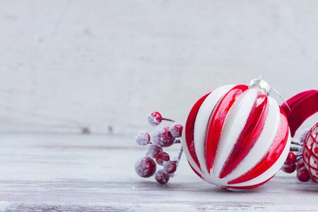 red and white christmas - ball and berries on aged wooden background with copy spaceの写真素材