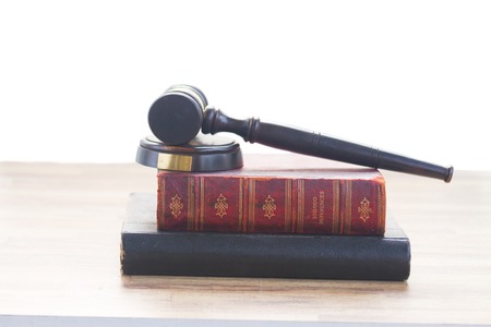 Wooden Law Gavel on books over whte backgroundの写真素材