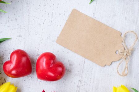 two red hearts for valentines day with empty paper tag