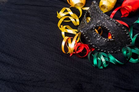 Mask with masquerade decorations on dark silk backgroundの写真素材