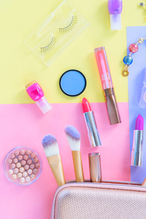Colorful make up products with pursue pop art flat lay sceneの写真素材