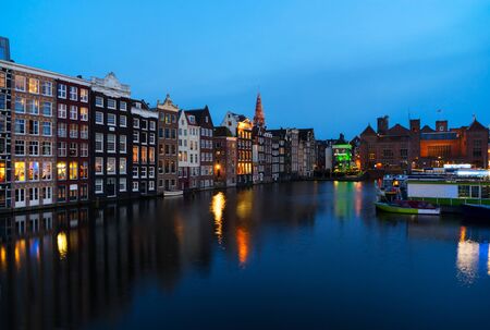 Houses over canal with mirror reflections at blue night, Amstardam, Netherlandsの写真素材