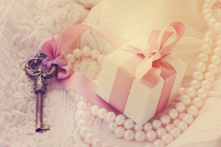 gift box and key with pearl jewellery and white lace, retro tonedの写真素材