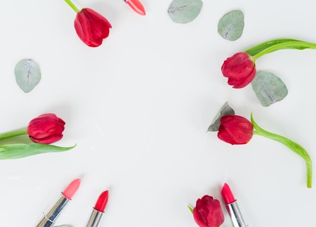 Colorful lipsticks and flowers flat lay frameの写真素材