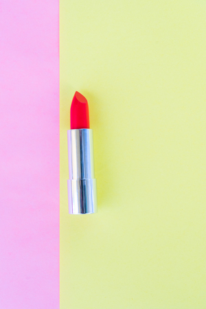 Colorful open red lipstick pop art flat lay sceneの写真素材