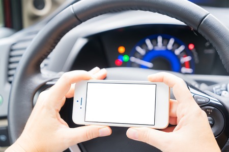 driving car and phone with empty screen for copy space close up