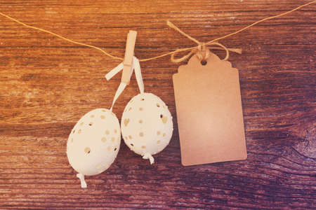 hanging white easter eggs with blank paper note , retro tonedの写真素材