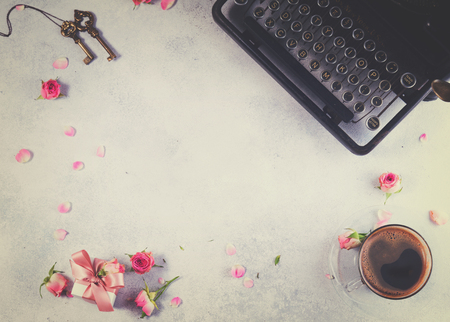 Workspace frame with vintage typewriter, coffee and keys, retro tonedの写真素材