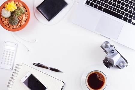 Styled workspace with laptop, phone, notebook and coffee, flat lay top view frameの写真素材