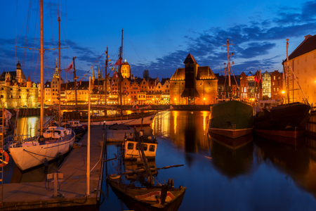 Night in Gdansk - old town waterfront with ships harbor illuminated in night, Gdansk, Poland