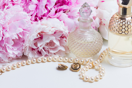 Wedding lifestyle with fresh peony flowers, glamour bottles and jewellery close upの写真素材