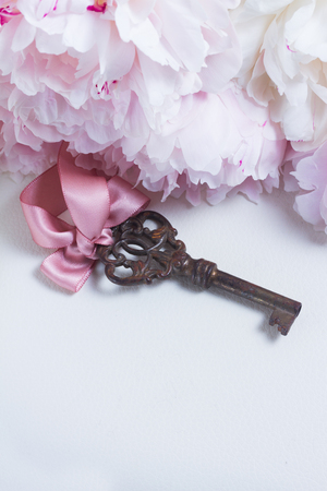 Skeleton key with peony flowers with copy space - love and wedding conceptの写真素材