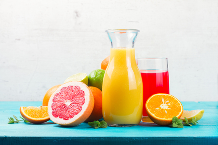 Citrus fresh juices - red and yellow one with oranges and grapefruitsの写真素材
