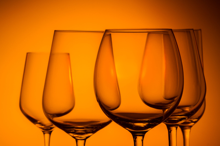 Set of wine glasses on orange background close upの写真素材
