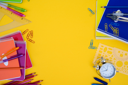 back to school styed scene with school supplies on yellowの写真素材