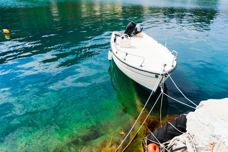 Fishing small boat floating in water, beautiful detail of Zakinthos island, Greeceの写真素材