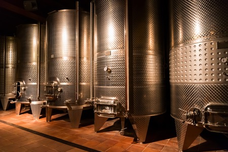 cellar with modern metal wine barrels rowsの写真素材