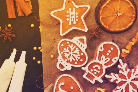 christmas gingerbread cookies with dried orange on cooking paper, retro tonedの写真素材