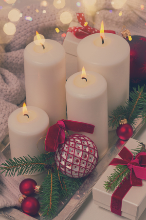 White burning advent candles with christmas decorations close up, retro tonedの写真素材